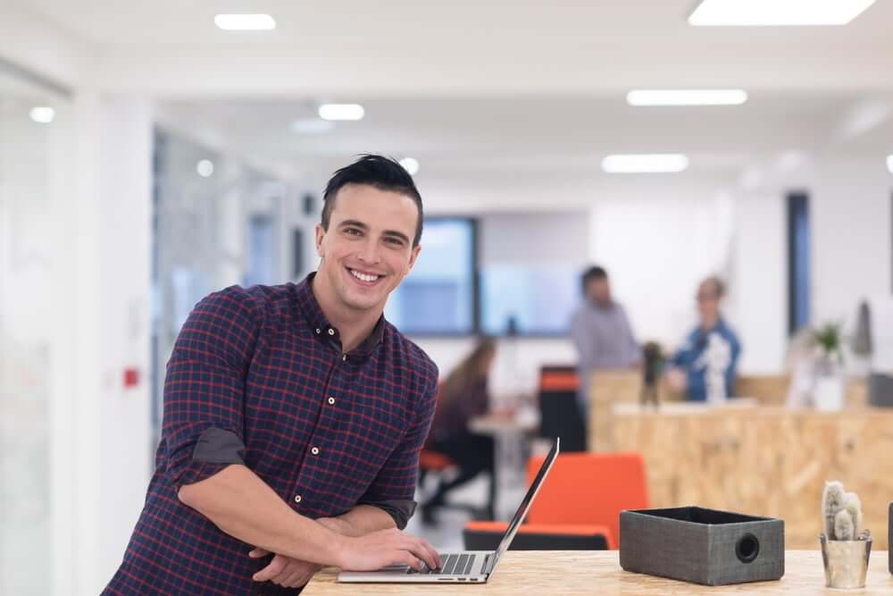 portrait of young businessman in casual clothes at modern  startup business office space,  working on laptop  computer-1 (1)